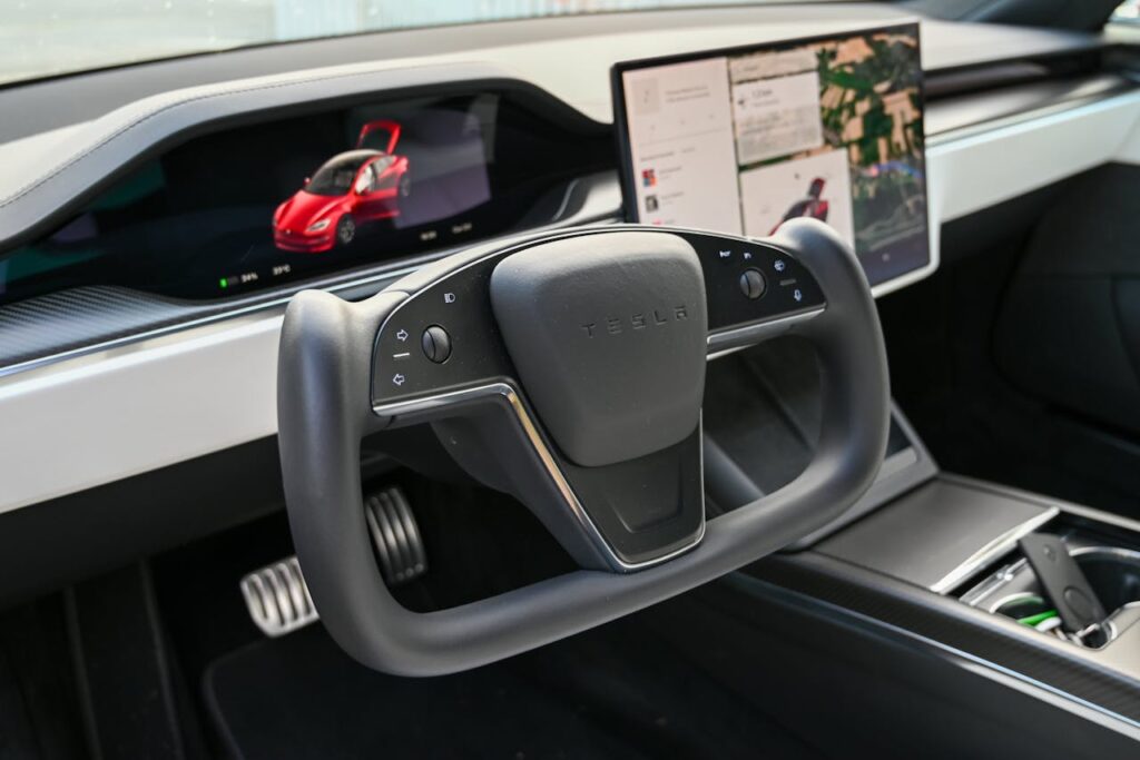 Steering Wheel and Screens in Tesla Car Interior 
